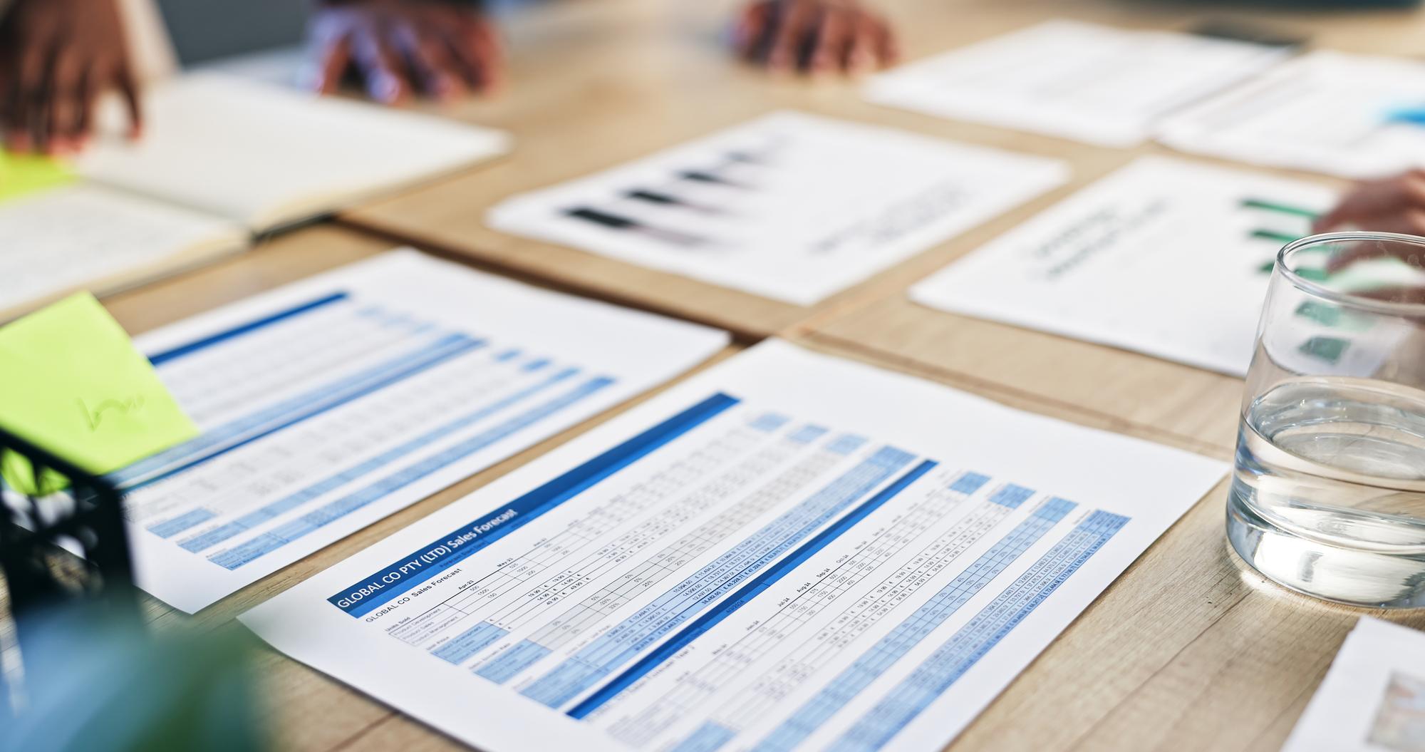 Stack of printed checklists and a compliance report
